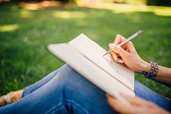 A woman journaling in the park