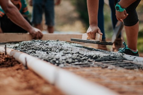 a work crew building the foundation for a house