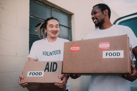 two happy guys volunteering