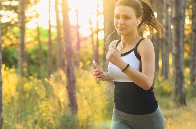 a woman jogging with a look of contentment on her face