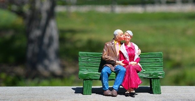 A happy older couple sitting together on a bench