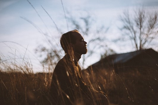 a man meditating in a field