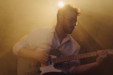 a man playing guitar on stage