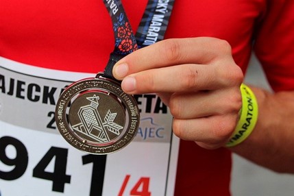 a marathon runner with a medal around his neck