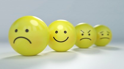 Four yellow balls showing different emotions