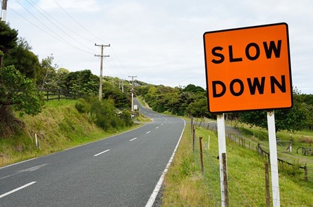 A traffic sign that says "slow down."