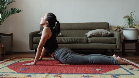 a woman doing the yoga pose "cobra"