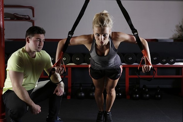 A determined woman exercising with a trainer