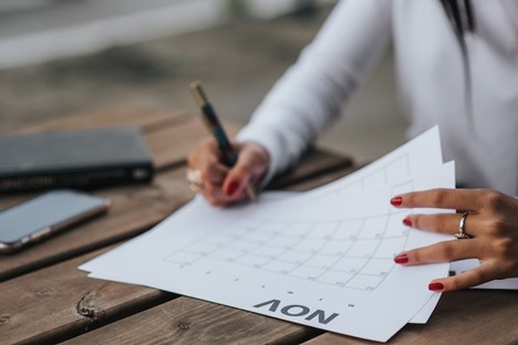 A woman working on a calendar.