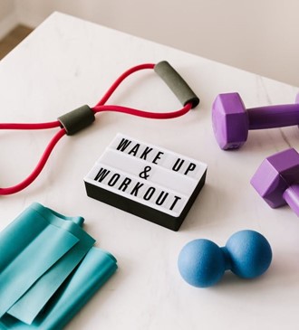 a variety of exercise equipment and the mantra "wake up and work out"