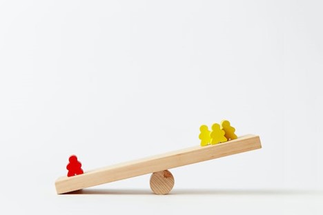 A seesaw with a red figure weighing down one end and three yellow figures raised on the other end