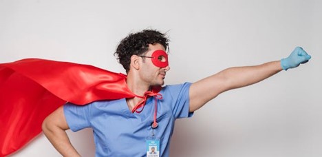 A nurse looking heroic in a superhero outfit