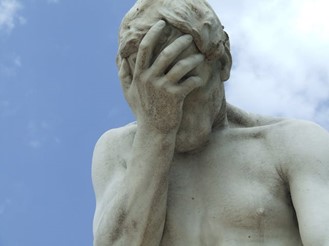 a statue doing the facepalm