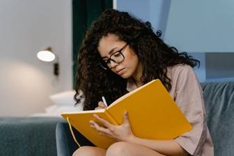 A woman filling out her planner at night