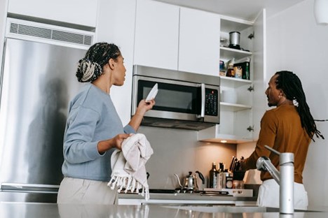 a couple arguing over chores in the kitchen