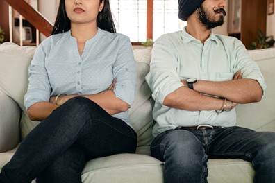 an unhappy couple on the couch