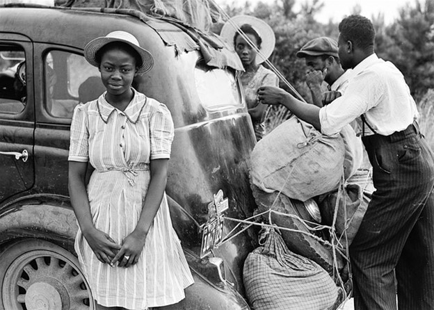 an African American family loading up their car during the great depression