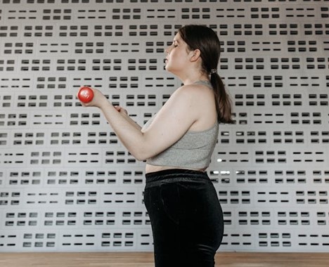 a person working out by lifting small weights