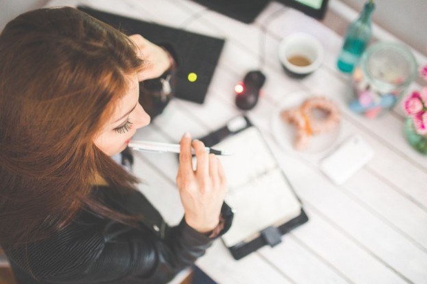 a busy professional woman thinking about how to better solve her problems