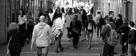 black and white image of pedestrians in a big city