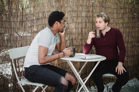 two men having a heart-to-heart over coffee