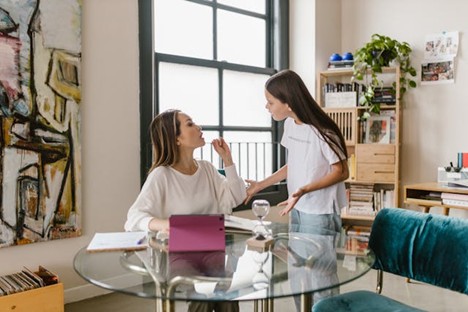a mom lecturing a defensive teenager
