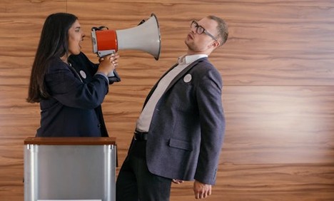 a woman yelling at a man through a bullhorn