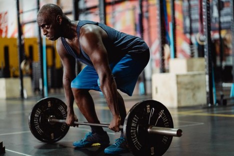 a man straining to lift heavy weights