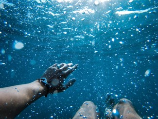 a person underwater looking up