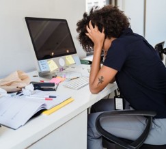 an overwhelmed person at their desk