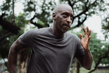 a middle aged man jogging with a look of determination