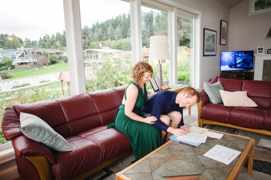 the two of us signing our marriage license in my parents' living room