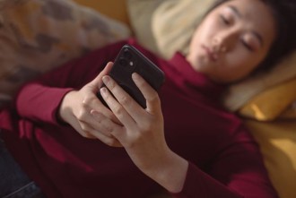 a person on their phone scrolling mindlessly